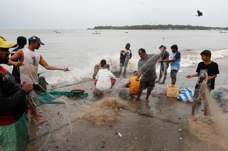 Fishermen gather their nets by the seashore to store them before cyclone Nisarga makes landfall, in Mumbai. Reuters