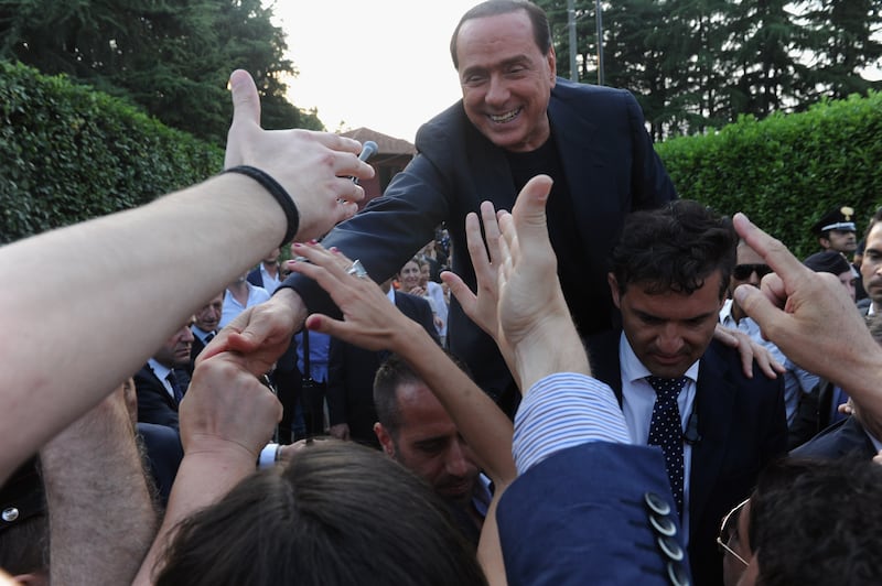 Berlusconi hails supporters outside his house, Villa San Martino, in Milan, July 2013. Getty