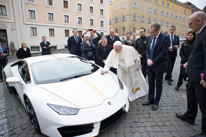 Pope Francis signs his new Lamborghini Huracan at the Vatican. Don't expect top see him in it instead of the popemobile any time. It will auctioned off with the proceeds donated to charity.  Osserrvatore Romano / EPA