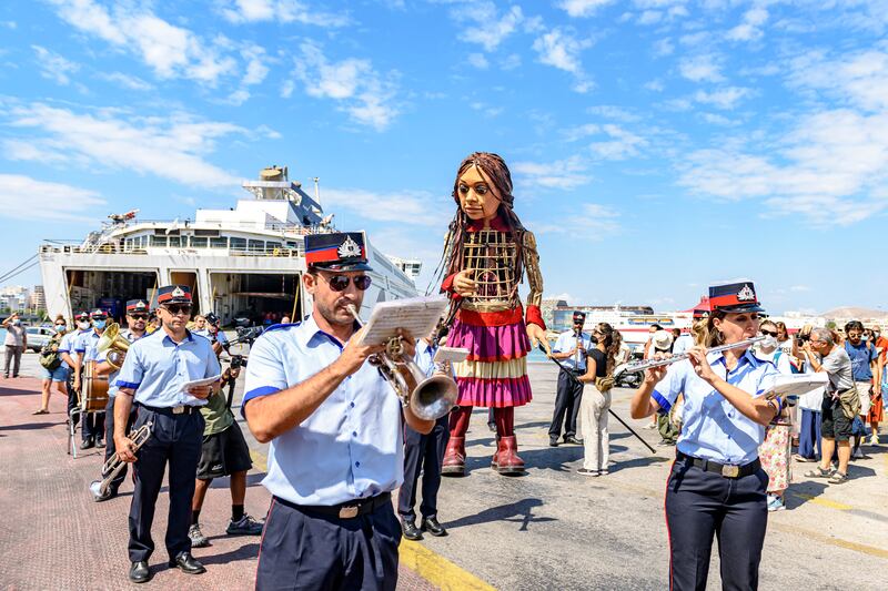 Little Amal was made by the puppeteers behind the runway hit, War Horse, and was built from moulded cane and carbon fibre to allow her to be operated for long periods and under various weather conditions. Piraeus, Greece. Photo: Elina Giounanli