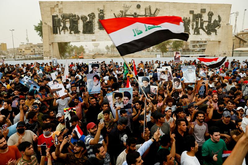 Supporters of Iraqi Shi'ite Muslim cleric Muqtada al-Sadr shout slogans during a celebration after Iraq's parliament passed a law criminalising normalisation of relations with Israel, in Baghdad, Iraq May 26, 2022.   REUTERS / Thaier Al-Sudani
