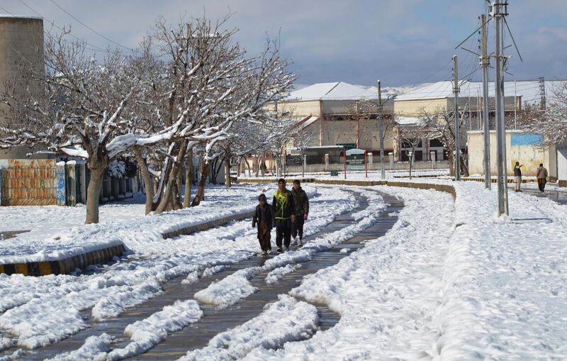 Youths walk on a snow-covered road after a heavy snowfall in Quetta. AP Photo