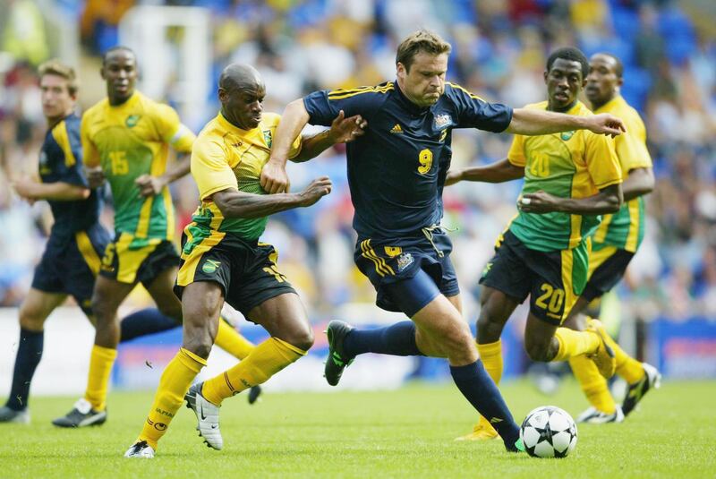 READING, ENGLAND - SEPTEMBER 7:  Mark Viduka of Australia is challenged by Franck Sinclair of Jamaica during the International friendly match between Australia and Jamaica at The Madjeski Stadium on September 7, 2003 in Reading, England. (Photo by Shaun Botterill/Getty Images)