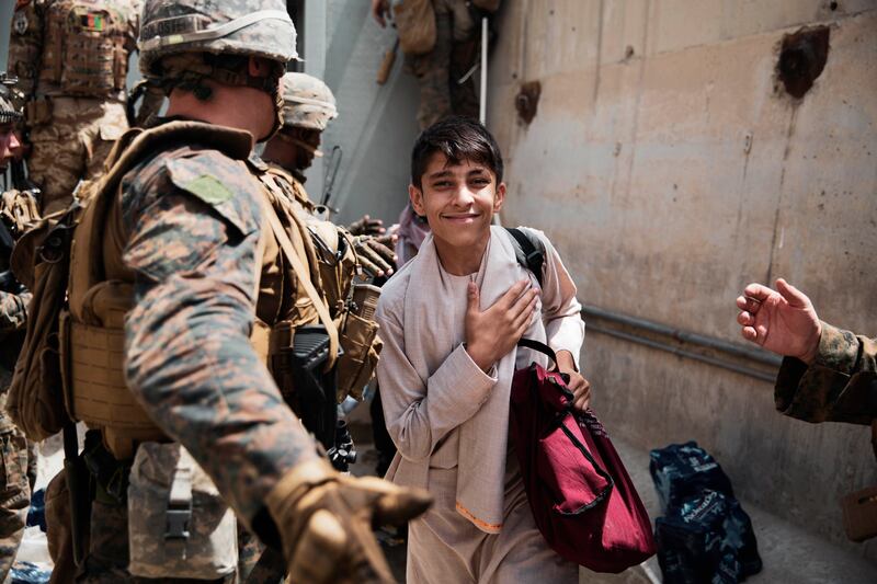 A boy is processed through an Evacuee Control Checkpoint at Hamid Karzai International Airport in Kabul, Afghanistan. AP Photo