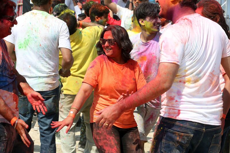 People dance while playing Holi at Al Mamzar Beach Park in Dubai. Pawan Singh / The National