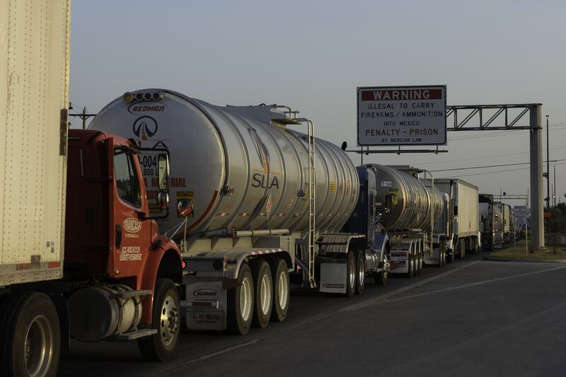 Several dozen commercial lorries wait to cross the Pharr-Reynosa International bridge in Pharr, Texas. AFP