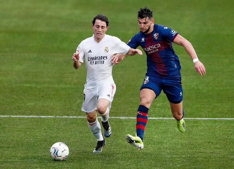 Real Madrid full-back Alvaro Odriozola hold's off Huesca's Rafa Mir. Reuters