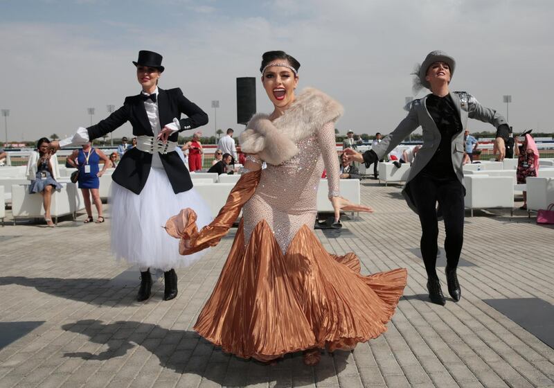 Well-dressed performers entertain the crowds ahead of the race. REUTERS