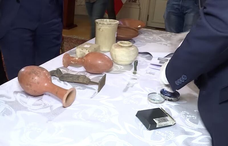 Egyptian experts and officials inspect recovered smuggled artefacts at the embassy in Paris. Screengrab