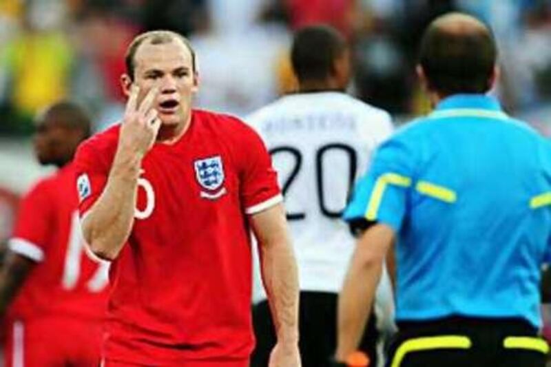 England's Wayne Rooney gestures towards Mauricio Espinosa, the Uruguayan linesman who failed to spot Frank Lampard's shot that had clearly crossed the line against Germany.