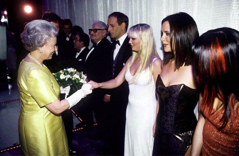The queen meets Spice Girls members Emma Bunton and Victoria Beckham. Getty