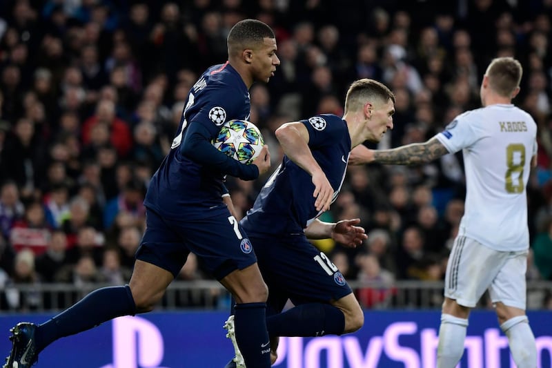 Paris Saint-Germain's French forward Kylian Mbappe (L) celebrates his goal with Paris Saint-Germain's Belgian defender Thomas Meunier during the UEFA Champions League group A football match against Paris Saint-Germain FC at the Santiago Bernabeu stadium in Madrid on November 26, 2019. (Photo by JAVIER SORIANO / AFP)