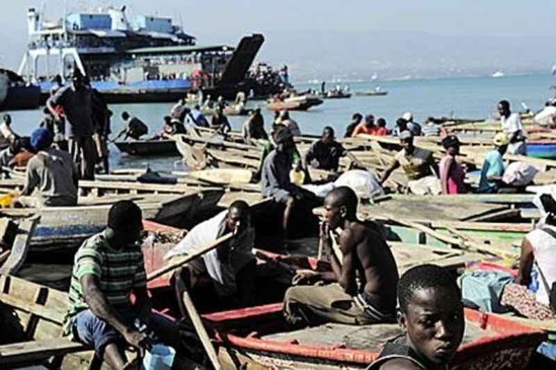 Thousands of Haitians wait at the port as they attempt to leave Port-au-Prince 12 days after the earthquake.