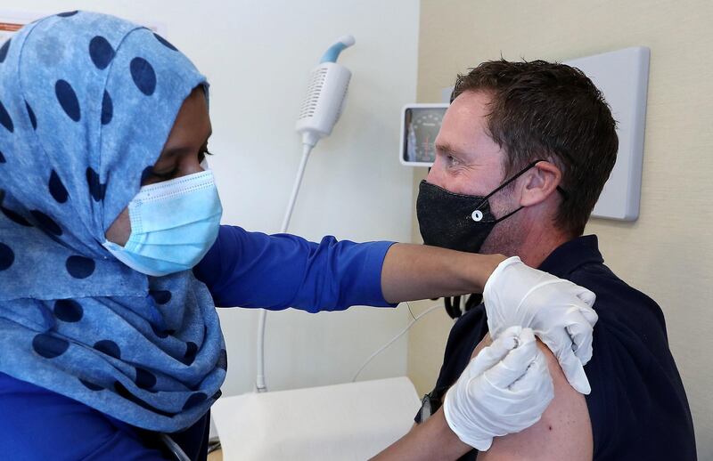 DUBAI, UNITED ARAB EMIRATES , September 16 – 2020 :- Resy Hussain, Nurse giving the Flu vaccine shot to Nick Webster at the Prime Hospital in Dubai.  (Pawan Singh / The National) For News/Online. Story by Nick Webster
