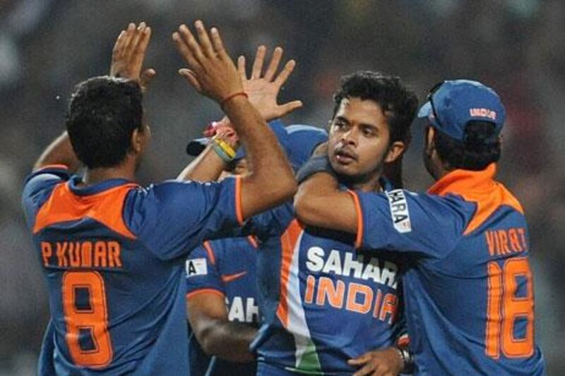 Santhakumaran Sreesanth, centre, seen in action in the 2011 World Cup final for India, was one of three cricketers to be arrested by Delhi police. Manan Vatsyayana / AFP