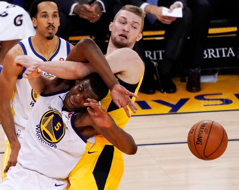 Golden State Warriors forward Kevon Looney, left, and Indiana Pacers centre Domantas Sabonis battle for a rebound during the second half of their NBA basketball game at the Oracle Arena in Oakland, California. John F Mabanglo / EPA