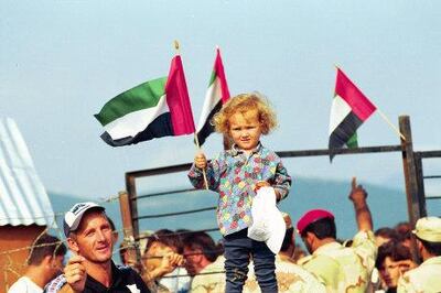 A young girl waves the UAE flag as refugees prepare to return home from Albania to Kosovo. Courtesy: Maj Gen Obaid Al Ketbi