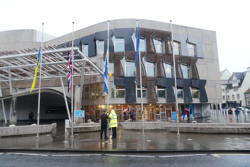 Flags being lowered to half mast outside The Scottish Parliament building at Holyrood in Edinburgh following the announcement of the death of Queen Elizabeth II. PA