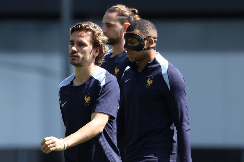 Antoine Griezmann, left, midfielder Adrien Rabiot, centre, and Kylian Mbappe in training on Monday. AFP