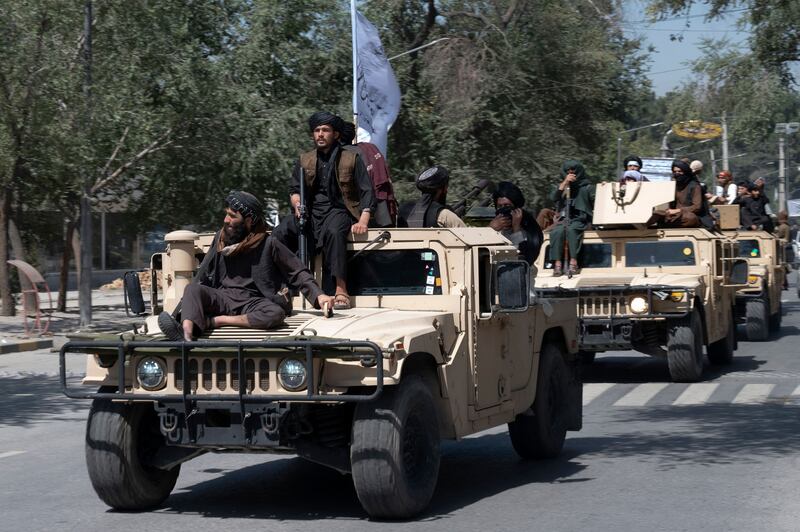 Taliban fighters take to the streets to celebrate. AFP