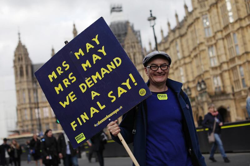 A protester stands outside the Houses of Parliament during the Put It To The People March. Getty Images