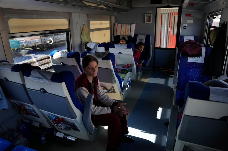 A woman and children inside a train being used as shelter after the earthquake, in Iskenderun. AP Photo