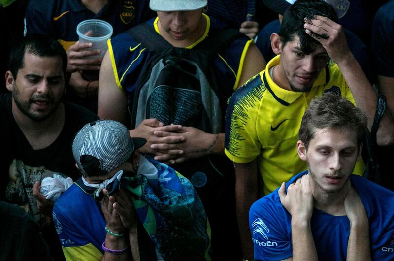 Fans of Boca Juniors in Buenos Aires' La Boca neighbourhood react after their team's loss. AFP/RAGGIO ALBERTO