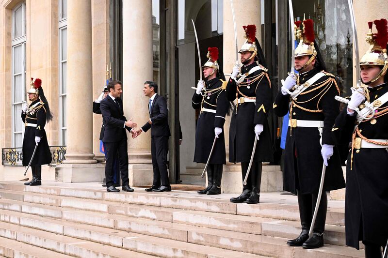 Guards at the palace stand in formation as Mr Sunak arrives. AFP