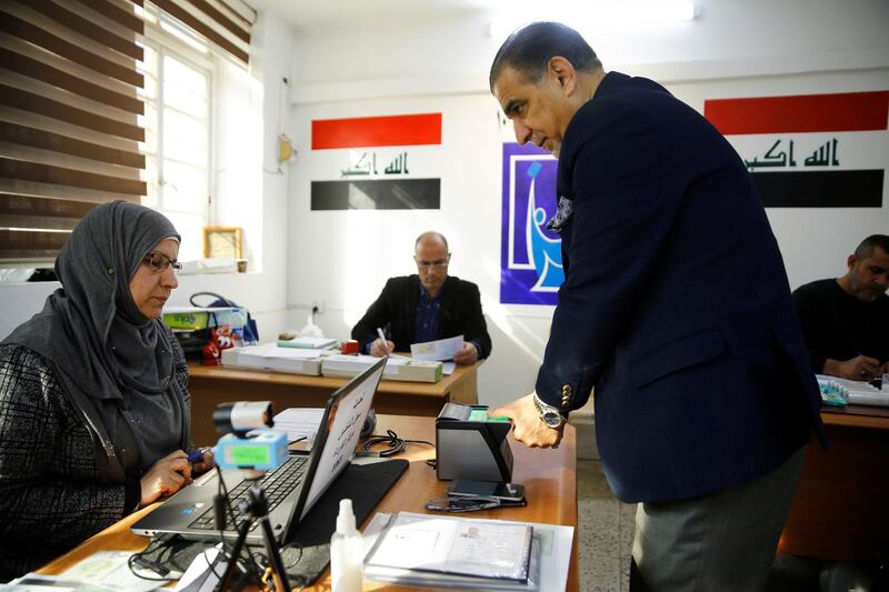An Iraqi man updates his voter ID registration at an Independent High Electoral Commission center in Baghdad, Iraq January 20, 2021. REUTERS/Thaier al-Sudani