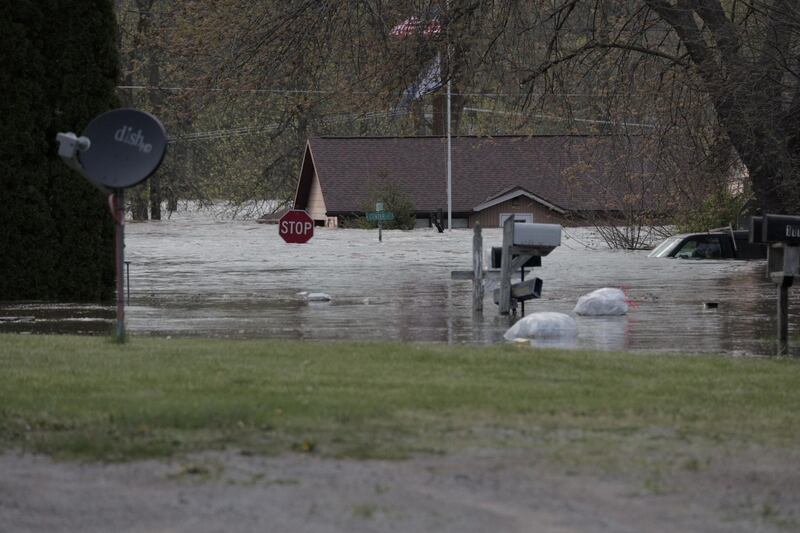 Vehicles and signs are submerged as floodwaters in downtown Sanford, Michigan. TC VORTEX via REUTERS