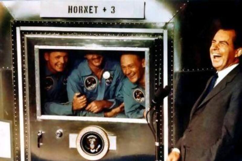 Apollo XI astronauts, from left, Neil Armstrong, Michael Collins and Buzz Aldrin laugh with President Richard Nixon aboard the USS Hornet, shortly after their splashdown in the Pacific on July 24, 1969.