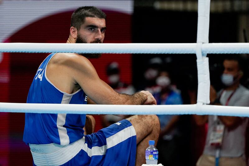 France's Mourad Aliev sits at ringside in protest at his disqualification.
