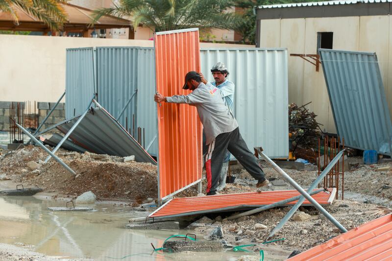 Restoration work gets under way after the rain in Khalifa City, Abu Dhabi. Victor Besa / The National
