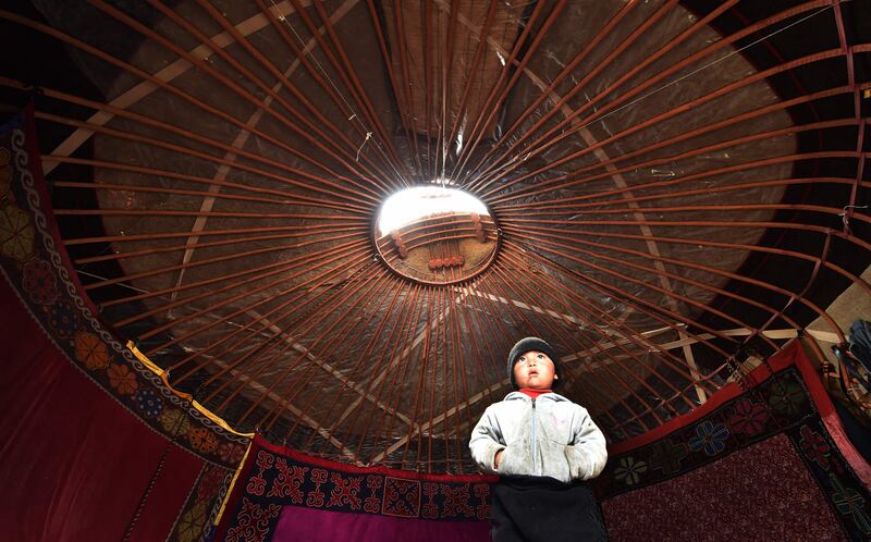 A boy stands in a yurt, the traditional portable dwelling of nomads on the Suusamyr Plateau in Kyrgyzstan. AFP