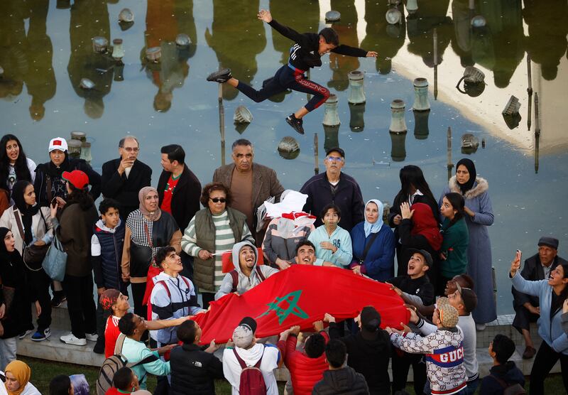 Fans prepare for the return of the Morocco football team with flags in the capital Rabat. Reuters 