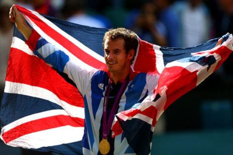 Andy Murray poses with his gold and silver medals at London 2012