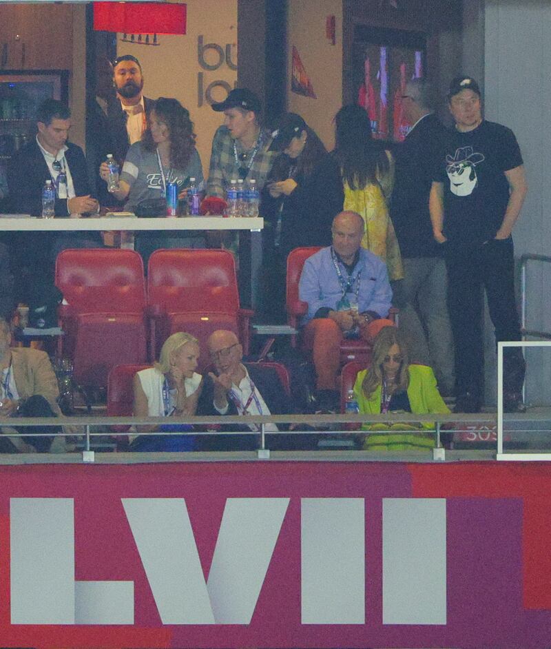 Rupert Murdoch sits in the front row as Elon Musk stands behind him dressed in a black T-shirt and baseball cap. Reuters