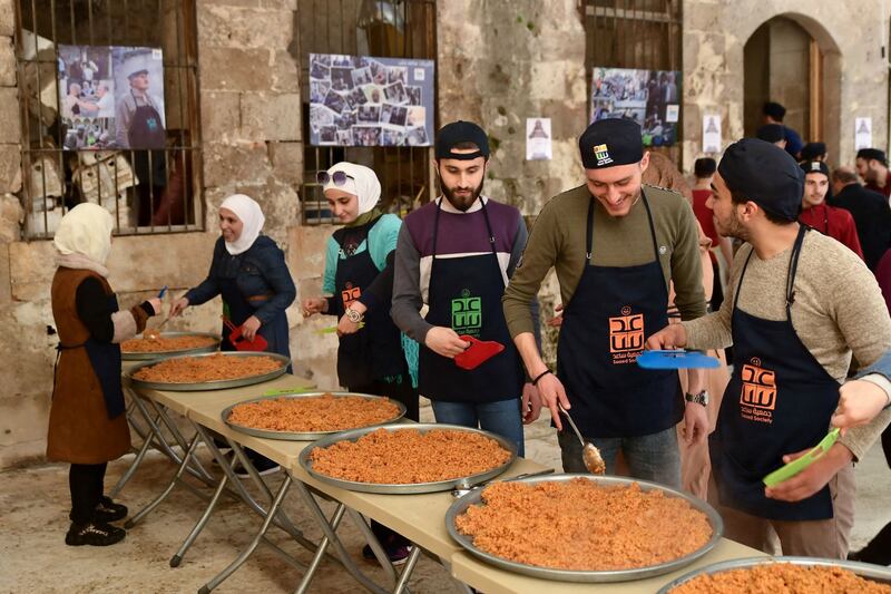 Volunteers from the charity Saaed, which means assist in Arabic, provide iftar for residents in Syria's northern city of Aleppo. AFP