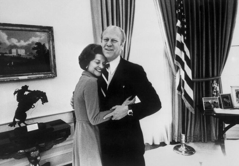 President Gerald Ford hugs his wife Betty inside the White House on December 30, 1974. AFP 