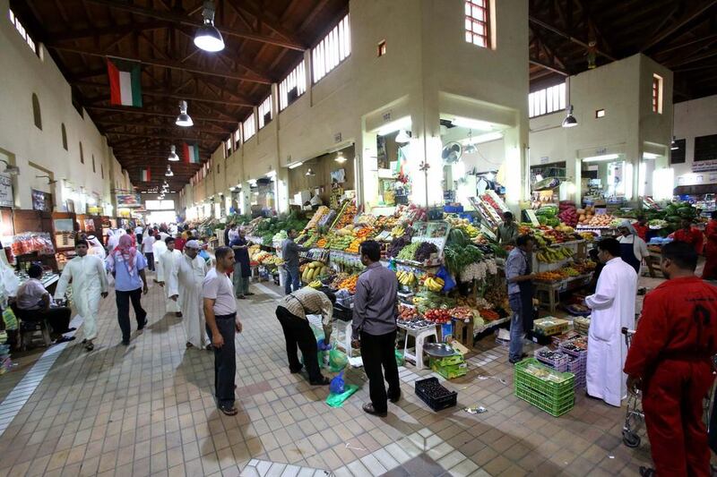 A fruits and vegetables market in downtown Kuwait City. The IMF has repeatedly urged Kuwait to reduce subsidies as spending rises. Yasser Al Zayyat / AFP