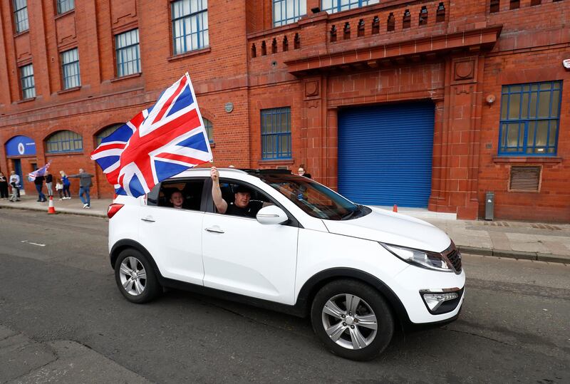 A Rangers fan celebrates in Glasgow on Sunday.