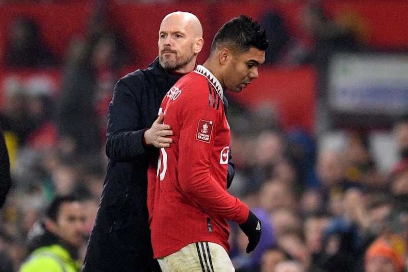 Manchester United manager Erik ten Hag with Casemiro after the midfielder is substituted during the FA Cup fourth round match against Reading. AFP