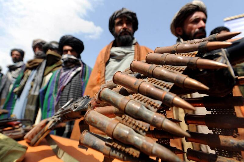 Former Taliban fighters display their weapons as they join Afghan government forces during a ceremony in Herat province on May 2, 2012. Taliban insurgents in Afghanistan are reportedly growing in confidence as the US continues its on-going withdrawal from the country. Aref Karimi/AFP Photo