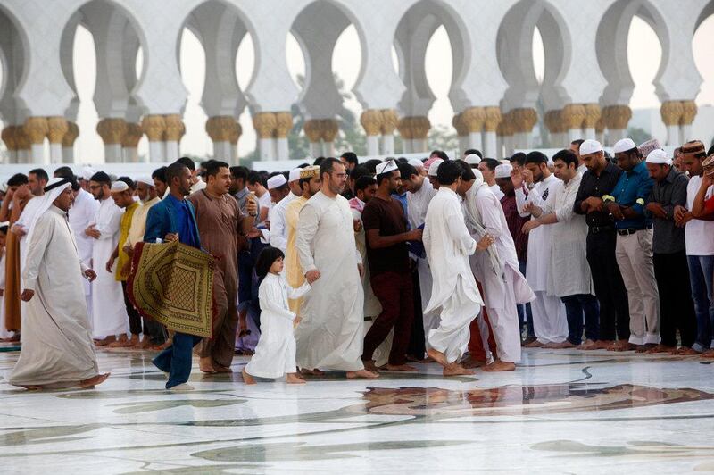 Men arrive for Eid prayers. Christopher Pike / The National