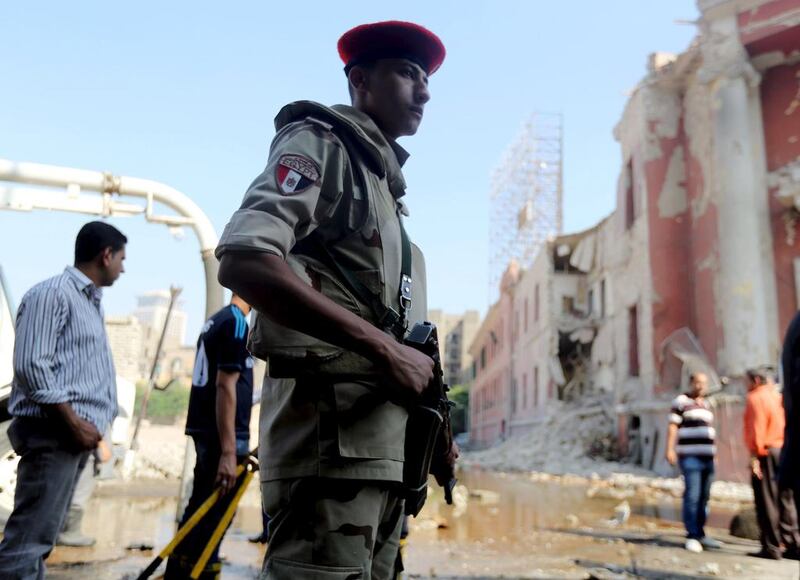 Egyptian security officials inspect the site of a bomb blast in Cairo in July 2015. Militants have killed police officers and bombed police headquarters in the capital. Reuters