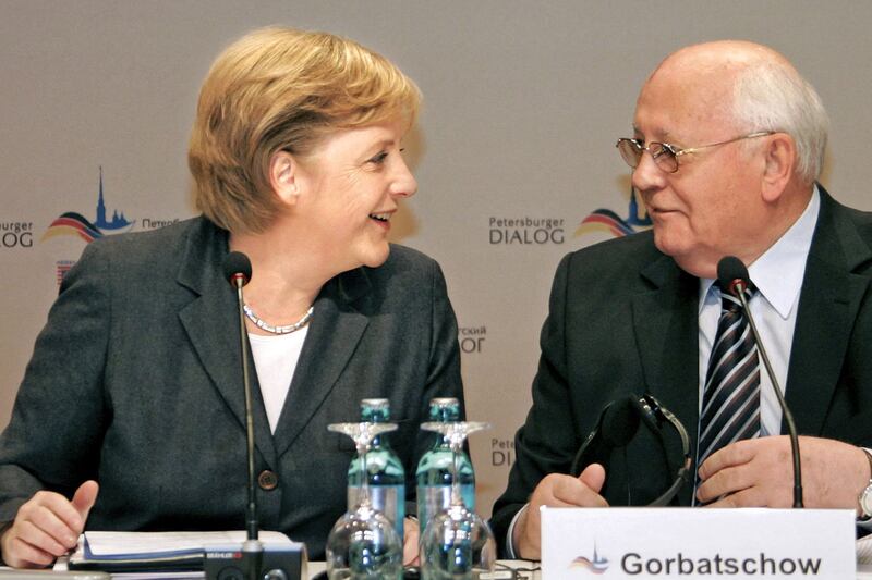Former German chancellor Angela Merkel and Gorbachev talk during the 'Petersburg Dialogue' conference in Wiesbaden, Germany, in October 2007. AFP
