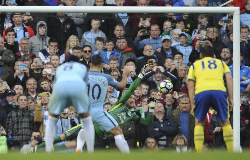 Everton's Maarten Stekelenburg, centre, saves a penalty from Manchester City's Sergio Aguero during their Premier League match at Etihad Stadium in Manchester on Saturday. Rui Vieira / AP Photo