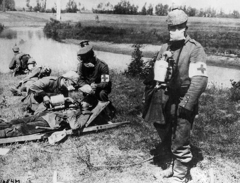 FILE - In this undated file photo from World War I, German Red Cross members carry bottles of liquid to revive those who have succumbed to gas bombs during battle. A century after German troops opened the taps on a line of chlorine tanks to send a poisonous cloud drifting across no man's land and into World War I Allied trenches, chemical warfare has come full circle. A report last year set up by the Organization for the Prohibition of Chemical Weapons said a toxic chemical, almost certainly chlorine, was used repeatedly in attacks on villages in Northern Syria. (AP Photo, File)