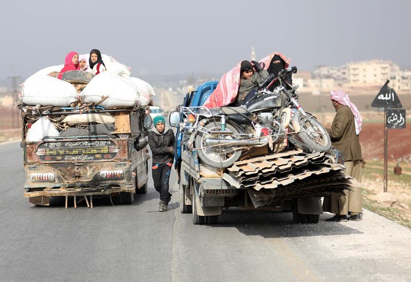 Displaced families from a village in southern Idlib head on the Damascus-Aleppo motorway towards the northern part of the rebel-held province on December 30, 2017. 
Syria government forces battle jihadist-led fighters on the edge of the rebel-held northwestern province of Idlib, as the jihadists pull out of a strategic enclave near Damascus. / AFP PHOTO / OMAR HAJ KADOUR