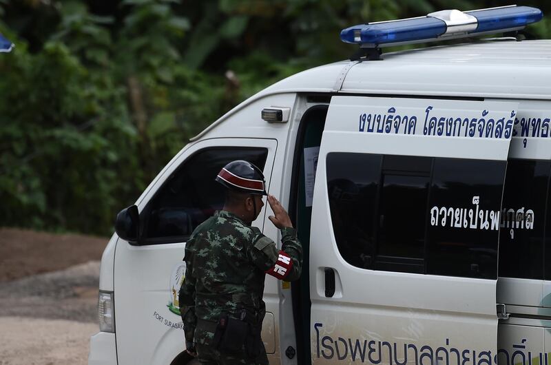 A Thai military police salutes an ambulance leaving from the Tham Luang cave area. AFP